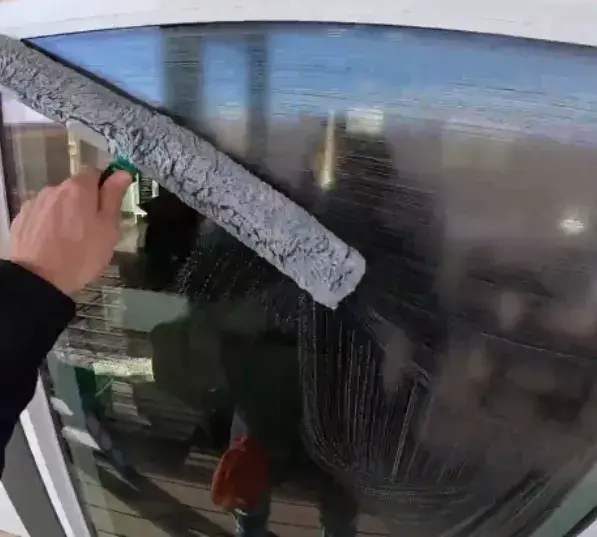 A Cleaner Cleaning A Residential Window A Cleaner Cleaning A Residential Window