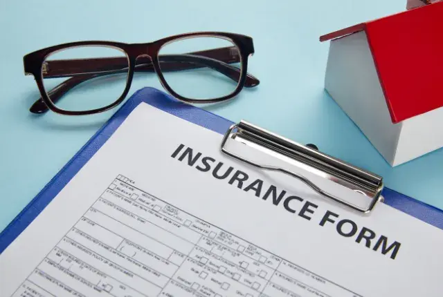 An Insurance Form Attached on A Clipboard An Insurance Form Attached on A Clipboard