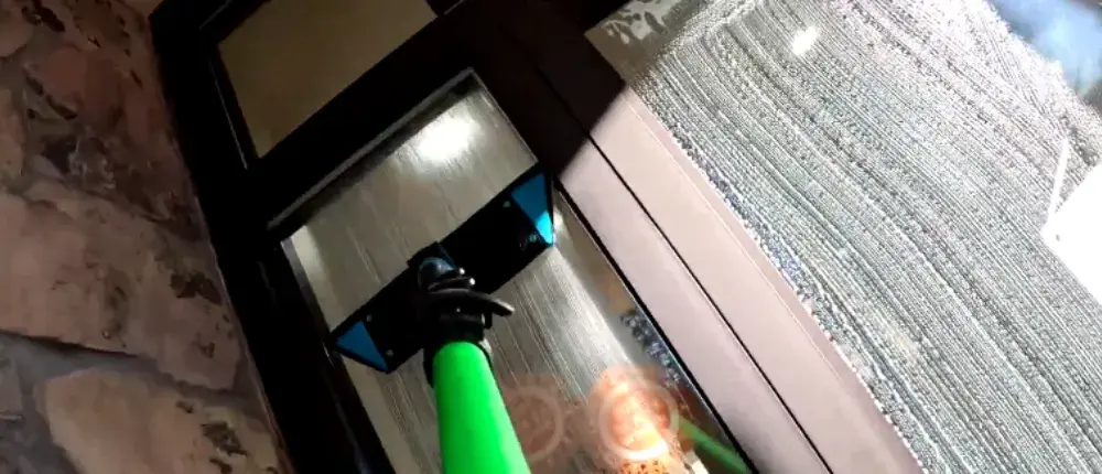 Professional Window Cleaner cleaning a storefront door